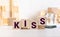 Kiss word written on wood cube with red background