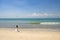 Kissing bride and groom with drone on beautiful beach, turquoise sea, Bali