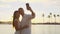 Kissing couple romantic at sunset on vacation taking selfie in love at beach