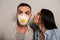 Kissing happy workman in safety mask