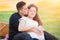 Kissing Hispanic Pregnant Young Couple Portrait Outdoors