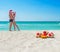 Kissing lovers couple in santa hats at sea beach