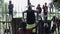 KISUMU,KENYA - MAY 21, 2018: African teenagers pump their muscles on horizontal bar outside, on the sports ground.