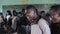 KISUMU,KENYA - MAY 21, 2018: Big group of african children dancing and singing together. Bald girls in uniform smiling.