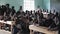 Kisumu,Kenya - May 21, 2018: Crowd of bald African children sitting at school desks. Boys and girls, teenagers in