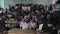 Kisumu,Kenya - May 21, 2018: View of the large classroom full of African children. Boys and girls smile and stand up.