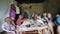 Kisumu,Kenya - May 23, 2018: Group of Caucasian people sitting in the house of poor African family and talking to them.