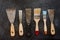 Kit of rusty old putty knives and brushes for repair and decorative works