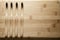 Kit of toothbrushes on the rustic wooden table in the bathroom. Warm and welcoming atmosphere.