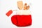 Kitchen accessories or kit of kitchenware packed in big red sock, white background. Kitchenware as wooden spoons and