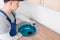 The kitchen assembler installs the sink in the countertop