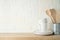 Kitchen background with dishware, utensils, cup and plate on wooden shelf