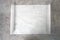Kitchen bakery white paper sheet top view on stone table.Food advertisement empty blank.Baking sheet, dish