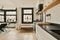 a kitchen with black counter tops and a window