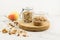 Kitchen board with glass jars filled with muesli or granola for making avtraka. nuts, ripe pear to improve the taste. healthy