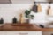 Kitchen brass utensils, chef accessories - blurred kitchen background . Hanging kitchen with white tiles wall and wood