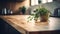 Kitchen brass utensils, chef accessories. Hanging kitchen with white tiles wall and wood tabletop.Green plant on kitchen