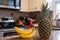kitchen with a bunch of bananas and pineapple on the foreground