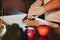 Kitchen chef starting to cut cucumber with a knife