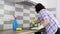 Kitchen cleaning, woman washing ceramic wall tile and glass electric hob