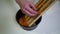 Kitchen. Close-up. A young woman is preparing food. Hands of the girl close-up. The woman puts the grated carrot in the