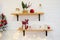 Kitchen cooking utensils in ceramic storage pot and Christmas decor on a shelfs