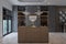 Kitchen Counter Behind a Home bar, and Chandelier hanging on the Ceiling. Home Decor