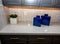 Kitchen Counter Top With Backsplash And Blue Ceramic Containers