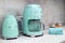 On kitchen counter top closeup in row SMEG brank kitchen appliances for easy life, coffee maker electric teapot , popular Italian