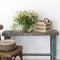 Kitchen decoration. A vase with wild-growing daisies on a shabby bench and a box for storing utensils with books