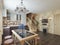 Kitchen and dining area in a log interior staircase to the second floor and a fireplace.