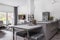 Kitchen with dining room table and grey design in fashionable house