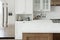 Kitchen with an emphasis on an empty countertop for arranging kitchen utensils.