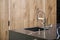 Kitchen faucet, modern kitchen in loft style, black marble table, wooden luxury kitchen