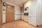 Kitchen furnished with white furniture and light-colored countertops