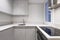 Kitchen with gloss gray wooden furniture combined with