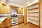 Kitchen with golden wood cabinets and hardwood floor.