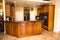 Kitchen With Granite Counters & Rich Wood Grain Cabinets