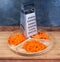 Kitchen grater, carrots grated finely, coarsely and sliced into circles