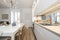 Kitchen with gray furniture with white stone countertop, mirrored wall,