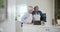 Kitchen, greeting and senior couple with a tablet, video call and communication with connection, apron and cooking. Home