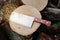 Kitchen hatchet knife machete at stump background chopped firewood.