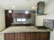 Kitchen of a house with marble pots and electric oven and glass windows