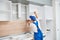 Kitchen installation. Worker assembling furniture