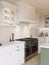 Kitchen interior with an emphasis on the oven and stove with hood.