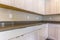 Kitchen interior of a house with white cabinets below the gleaming countertop