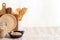 Kitchen jar with chickpeas next to a black plate with chickpeas inside, behind some cutting boards and kitchen utensils, copy