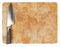 Kitchen knife laying on used chopping board
