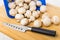 Kitchen knife, scattered mushrooms on bamboo cutting board