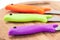 Kitchen knives with colorful plastic handles on a wooden board